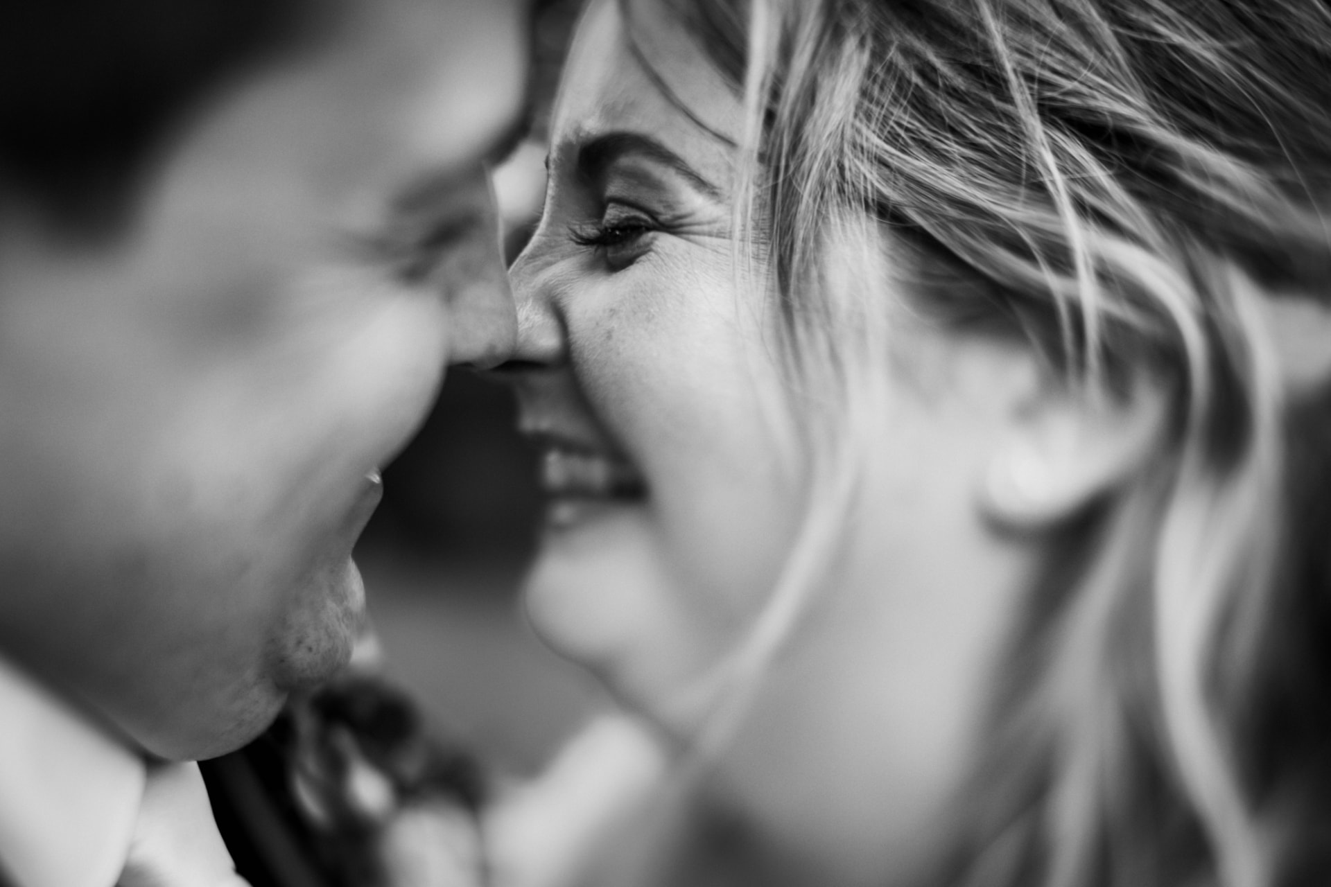 Close-up of a couple nose to nose, laughing, black and white